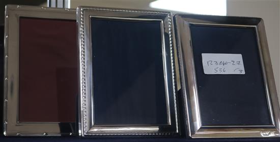 Three assorted modern silver photograph frames, largest 18.4cm.